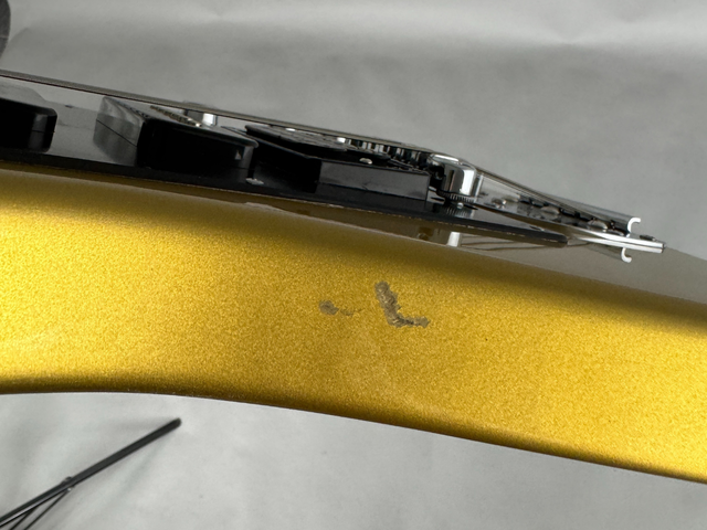 Small patch of worn finish on the side of the body